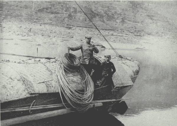 SCENE ON THE UPPER YANGTZE  Author and the cook on the aft of the houseboat after all the dangerous rapids had been passed. The ropes are made of bamboo. En route to Chung-king.