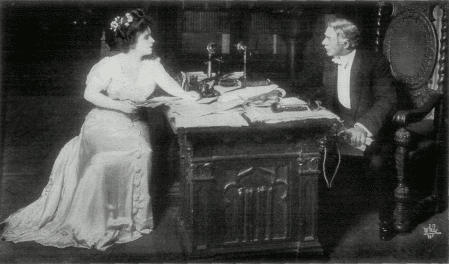 [Photo, from the play, of Shirley discussing her book with Mr. Ryder]