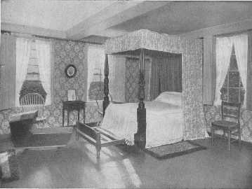 This fine well-curtained four poster, once the property of Lafayette, the trundle-bed, cradle, chairs and table, are all interesting, but the wallpaper appears to be of the ugly time of about 1880. Something more appropriate should be chosen.