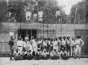 GROUP OF WORKERS ON CACAO ESTATE. Some are standing on the Drying Platform, which is the roof of the Fermentary.