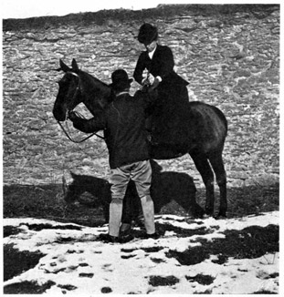 Woman preparing to dismount with a man offering a hand