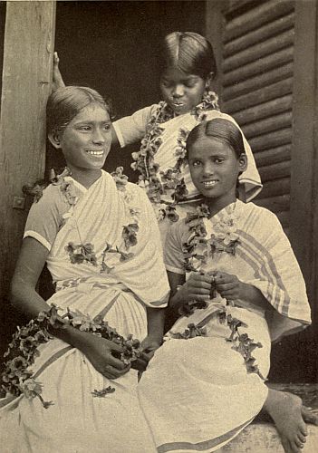 PREENA AND PREEYA (To left and right) getting ready for a Coming-Day Feast.