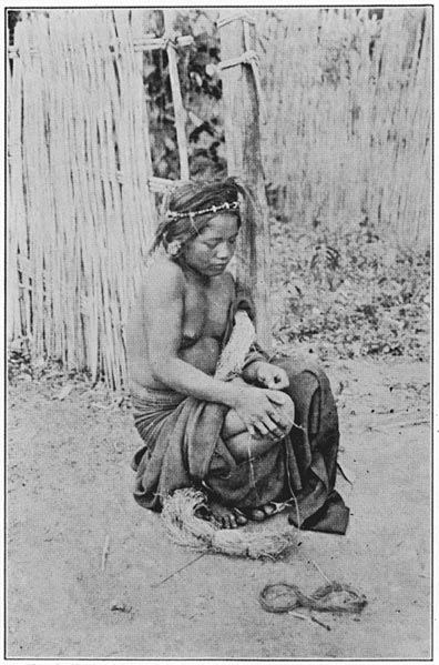 Woman spinning thread on her naked thigh