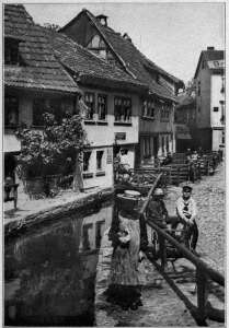 Copyright by Underwood & Underwood, N. Y. STREET SCENE AT EISENBACH, SOUTHERN GERMANY From the villages and small towns is recruited sixty per cent. of the German army.