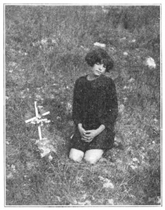 JEANNE WAS KNEELING BESIDE A CROOKED LITTLE BROWN CROSS