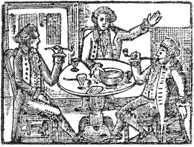 Three men at a table eating, drinking, and talking