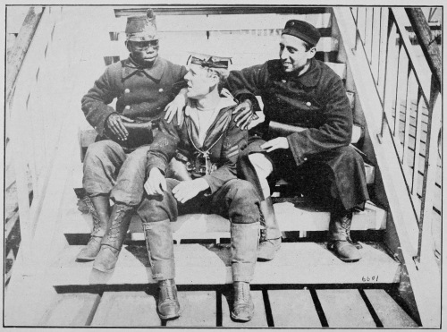 “ALLIES.” TWO BELGIAN SOLDIERS, ONE BEING FROM THE CONGO, HAVING A CHAT WITH A JACK TAR ON THE QUAY AT OSTEND.  Photo by International News Service. 