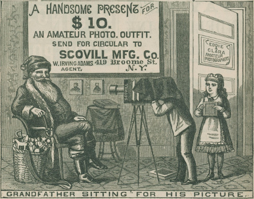 A HANDSOME PRESENT FOR   $10.   AN AMATEUR PHOTO. OUTFIT.   SEND FOR CIRCULAR TO   SCOVILL MFG. Co.   W. IRVING ADAMS      419 Broome St.   AGENT.                N.Y.   EDDIE   &   CLARA   AMATEUR   PHOTOGRAPHERS GRANDFATHER SITTING FOR HIS PICTURE.