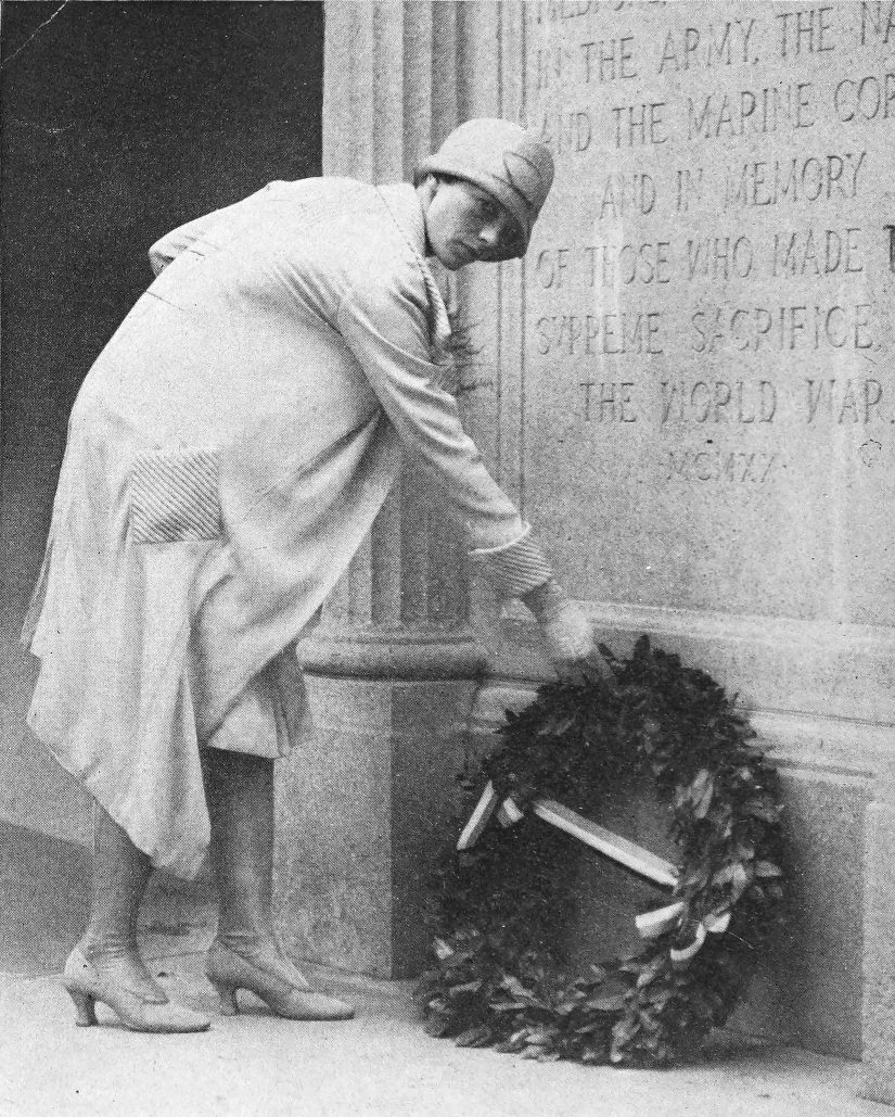 Photo full shot Earhart laying wreath at the base of                 the Medford, Massachusetts Honor Roll Memorial