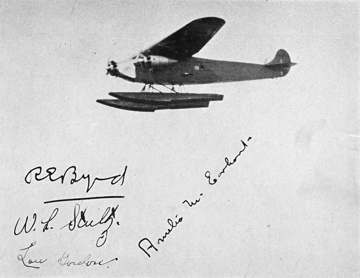 Photo wide shot of flying tri-motor plane with autographs by Byrd, Stultz, Gordon, and Earhart below