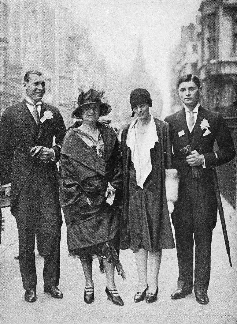 Photo full outdoor shot of Earhart standing next to a woman and two men who are in formal attire