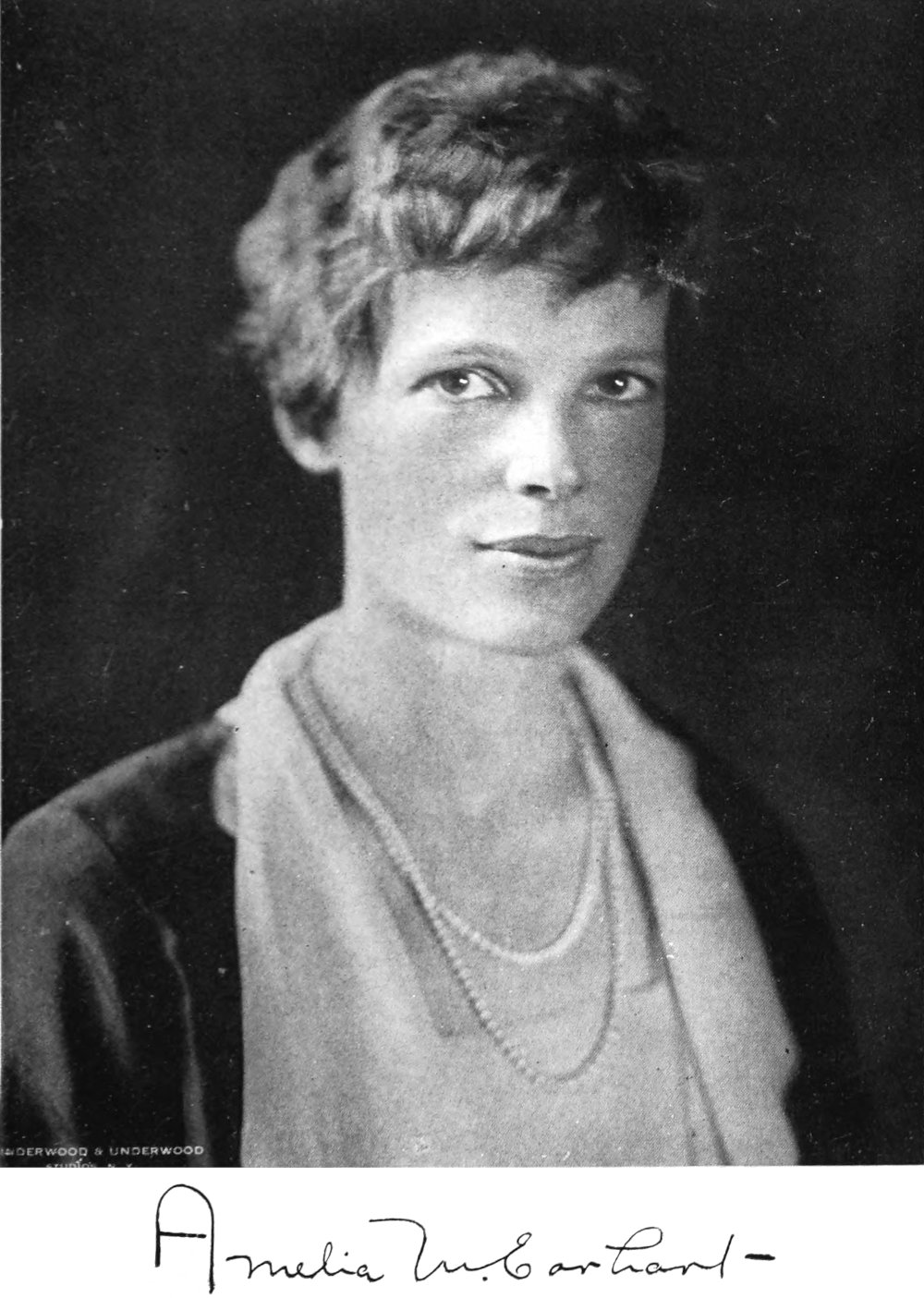 Photo close medium 3⁄4 view shot studio portrait of Amelia Earhart with signature below