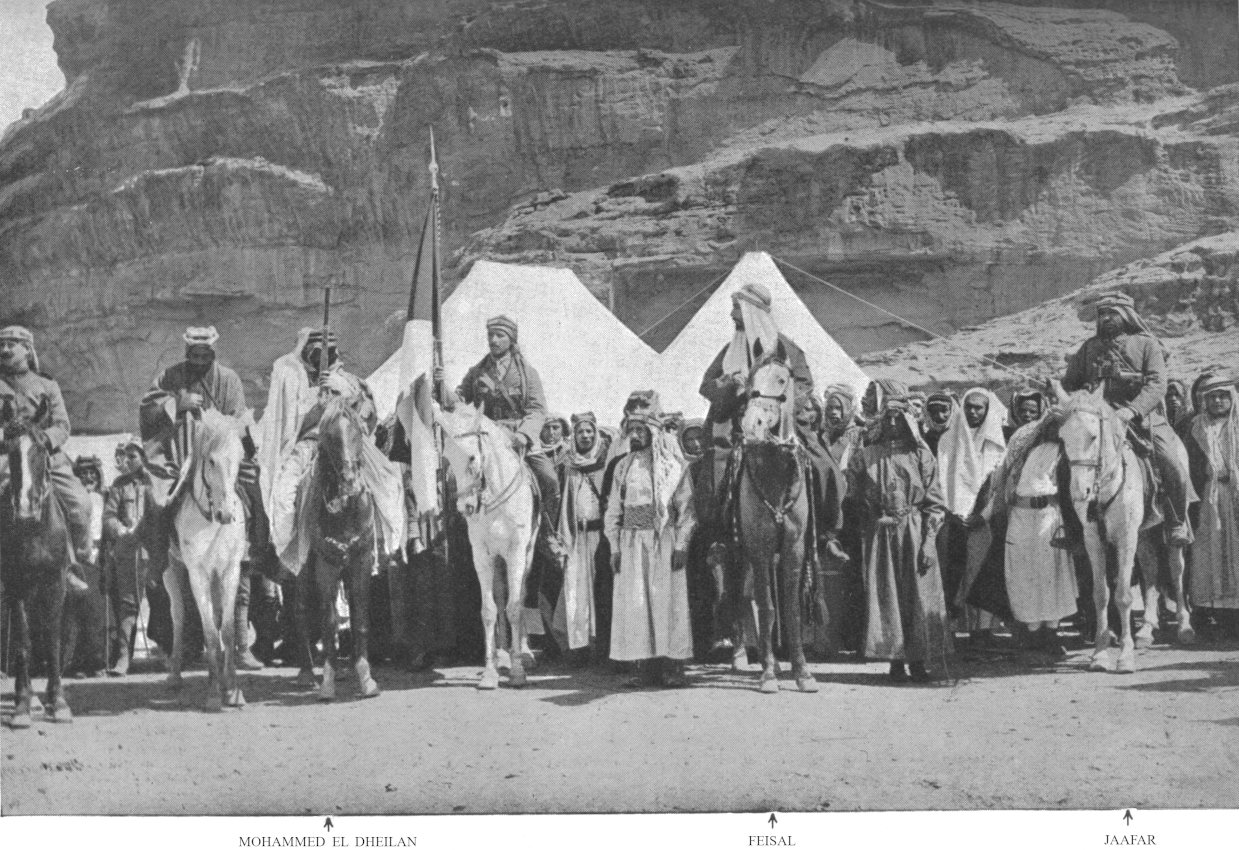 Photo wide shot of men standing and on horses facing                 forward; Mohammed el Dheilan, Feisal, and Jaafar                 indicated