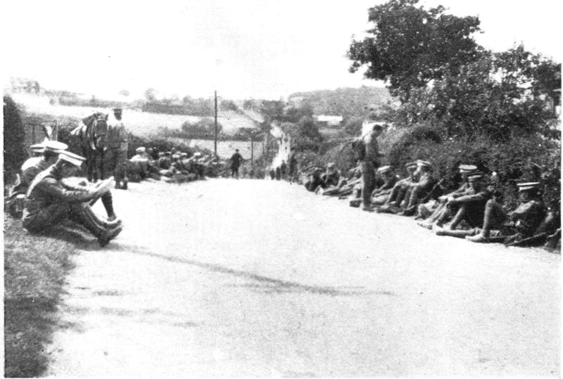 Troops resting at side of road