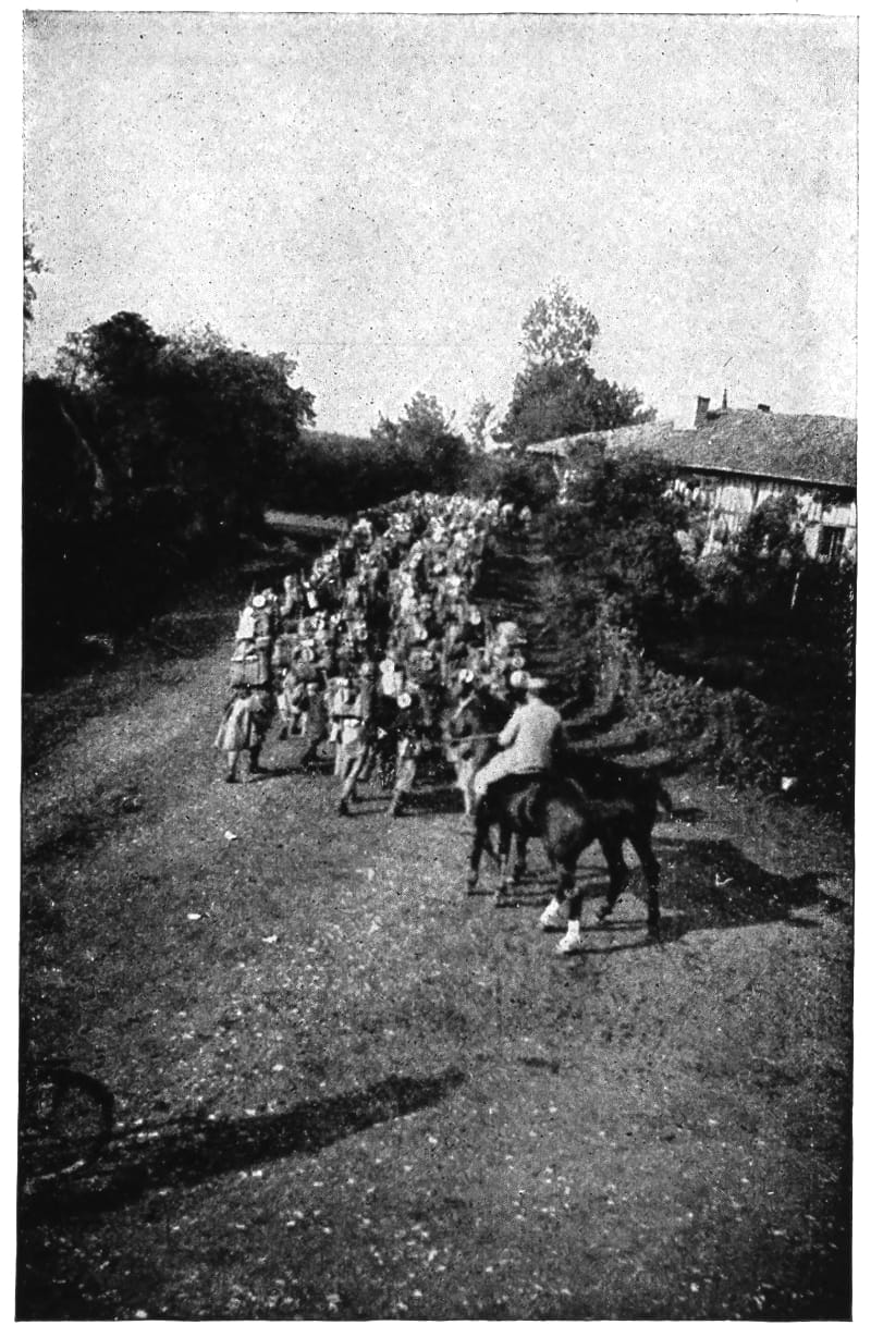 Uniformed men travel on foot while followed by a man on horseback.