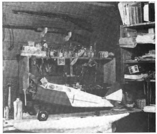 A model airplane in a shop with many tools