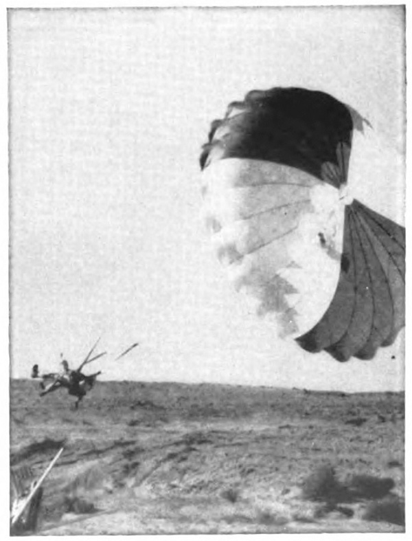 An object landing on the ground with an open parachute over it