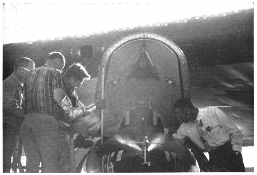 Men gathered around a plane, one of them climbing into the cockpit