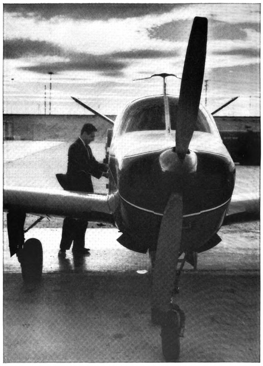 A man standing next to a plane with the dawn sky in the backgroun