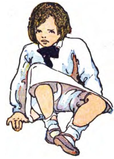 A child sits on the ground, looking slightly downward ahead. The child has short brown hair and wears a long-sleeved collared shirt in light blue or white with a large black bow at the neck. They wear light-colored shorts or a skirt, along with white socks and Mary Jane shoes.