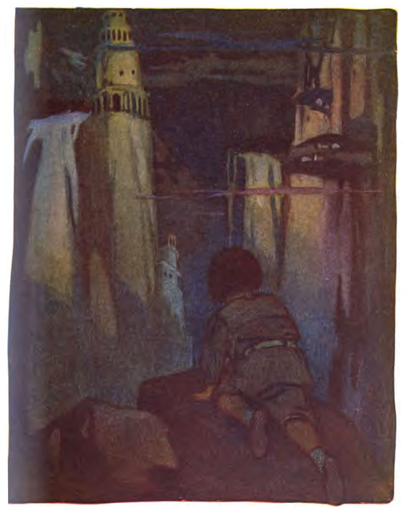 A child with short brown hair, wearing a brown tunic, socks, and shoes, kneels and looks toward a surreal dreamlike cityscape at night. On the left, a tall round white tower looks like a castle turret with small arched openings. In center-left midground, a smaller, ghostly white turret sits lower down.