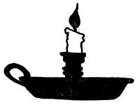 The black-and-white image shows a lit candle in a traditional chamberstick holder. The candlestick is short and unevenly melted, standing upright. At the top, a small teardrop-shaped flame flickers. The base is a flat, shallow pan to catch dripping wax. On the left, a simple curved loop forms the handle. In the center, a small tiered cylindrical column holds the candle in place.