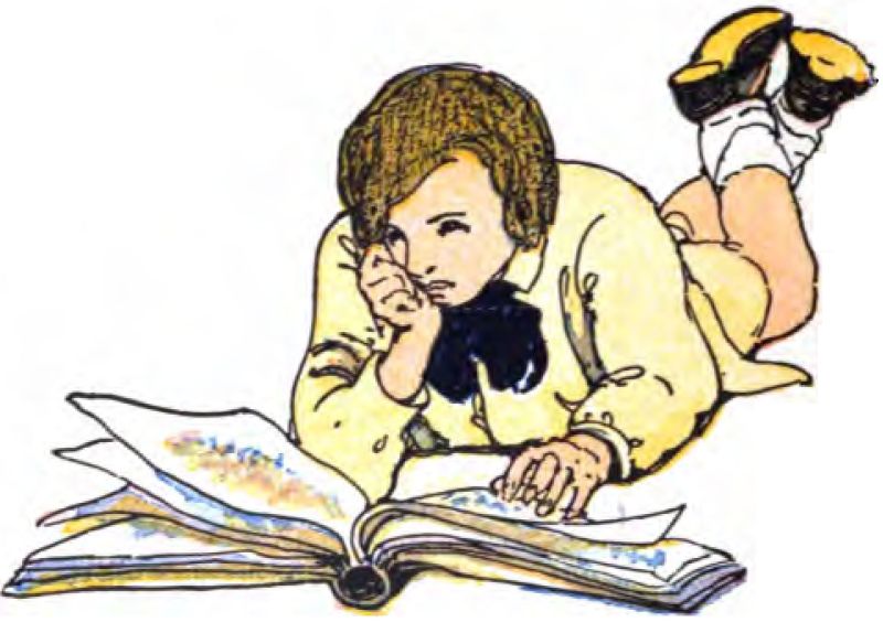 A young boy with wavy brown hair lies on his stomach, reading a book. He wears a pale yellow long-sleeved shirt with a dark blue or black bow at the collar. His legs are bent at the knees and kicked up behind him, showing white socks and dark shoes with yellow soles. He rests his chin on his right hand, while his left hand rests flat on the open book. The book is large and thick, lying in front of him. The pages are turning, and you can see faint, colorful hints of illustrations or text on them.