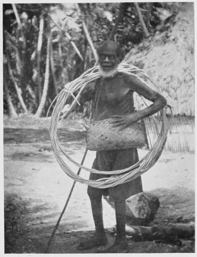 Bearded adult carries a satchel of supplies and a length of rope looped over his shoulder