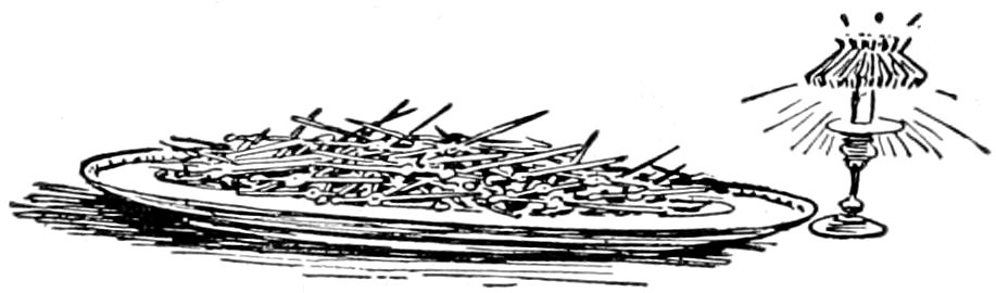 A platter piled high with second hands next to a lit lamp on a stand.