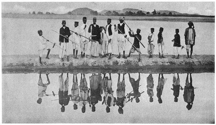 Throwing stilts into the water at the Pola festival