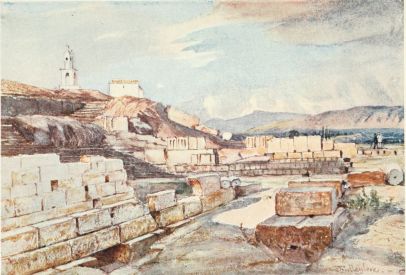 THE GREAT TEMPLE OF THE MYSTERIES, ELEUSIS. LOOKING
NORTH-EAST

On the left, in the immediate foreground, is part of the early girdle
wall of the sacred precincts, above which is the edge of the Acropolis
rock, with a chapel of the Panagia, and belfry above. To the right are
bases of votive offerings. In the distance are the mountains of
Attica.