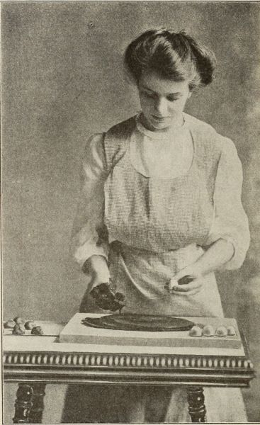 photograph of woman spreading chocolate on slab