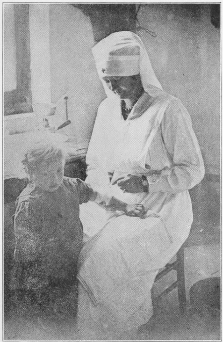AN AMERICAN WOMAN CARING FOR A LITTLE WOUNDED FRENCH CHILD