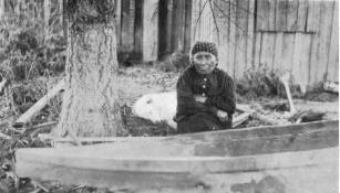 WATERMAN—CANOES

PL. IV

BOW OF THE HULL SHOWN IN PLATE V, VIEWED FROM THE SIDE, WITH THE MAKE1’S
WIFE, MARY ADAMS (TAI´PΔS) SEATED BESIDE IT

(Photograph by J. D. Leechman.)