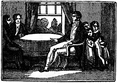 children huddled behind man seated at table with two other men