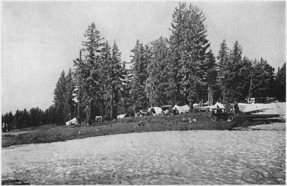 Campers at the Rim of Crater Lake. Mid-July Snow in Foreground