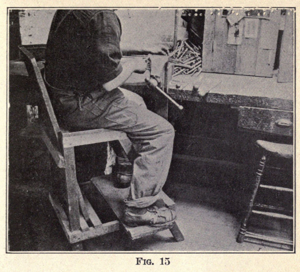 Fig 15 - A worker using the filer’s chair, shown in figures 13 and 14.