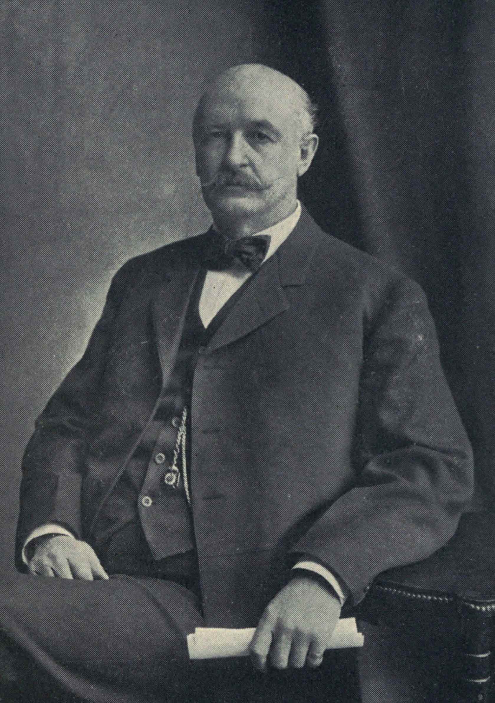 A formal
portrait of David Patterson Hatch, seated in a suit with bow tie,
holding a rolled paper.
