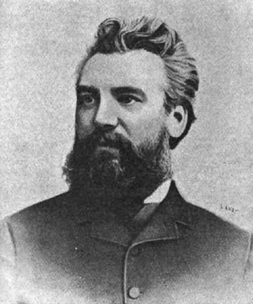 A photograph
of a bearded man with swept-back hair in 19th-century dress —
consistent with portraits of Alexander Graham Bell, inventor of the
telephone.