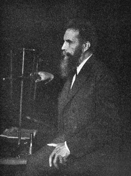 A photograph
of a bearded man in profile seated beside scientific apparatus —
consistent with portraits of Wilhelm Röntgen, discoverer of X-rays in
1895.