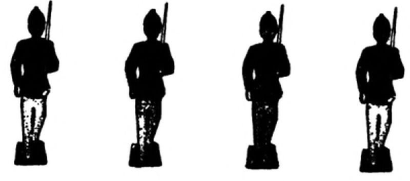 The image shows four black
toy soldier silhouettes standing side by side. Each stands on a
small square base. They wear pointed military hats, and each holds a rifle
upright on their shoulder.