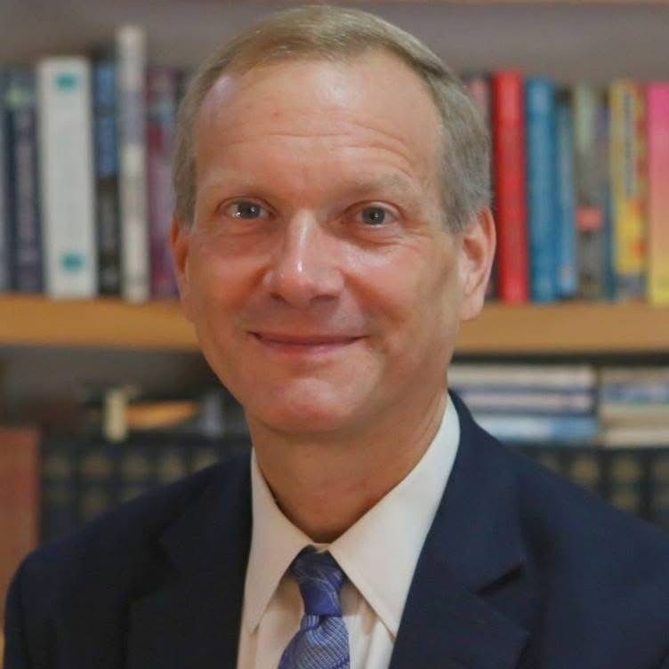 headshot of Greg Newby